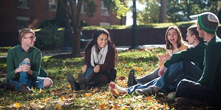 Group of students sit on college green