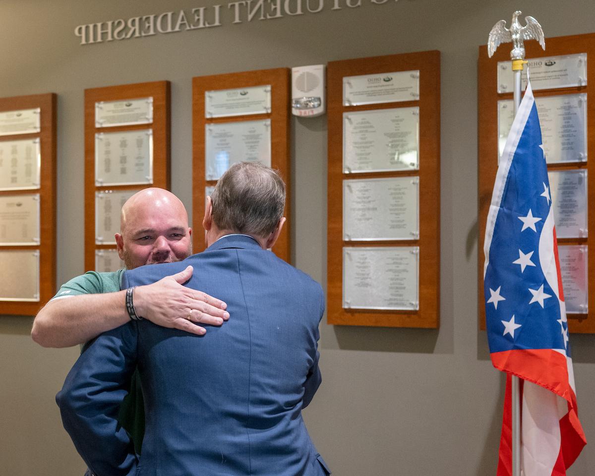 A veteran staff member congratulating a veteran