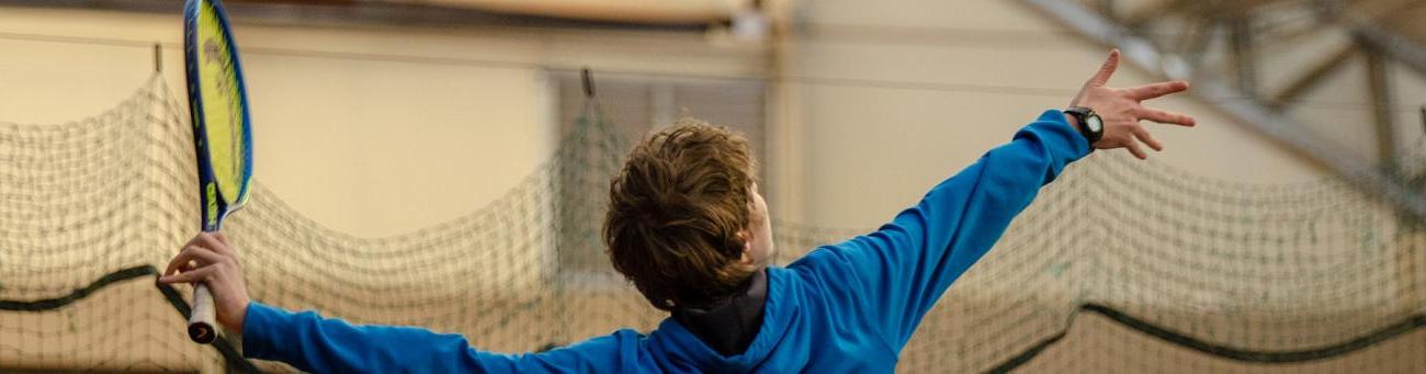 Tennis player prepared to hit ball with racket