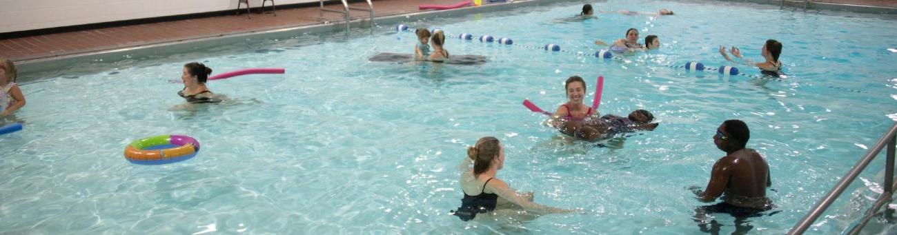 Many people playing in the pool at the Aquatic Center